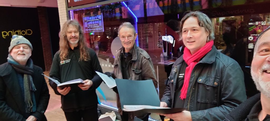 Côr busking in Hertford Street